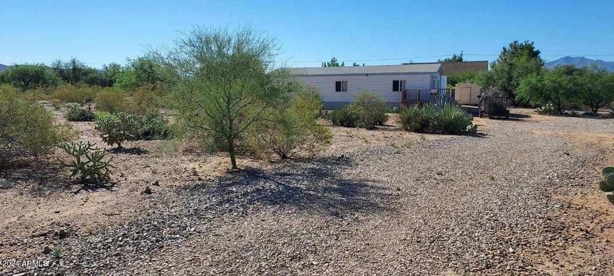 Seller will pay some Buyer Closing Costs! Beautiful Views! Feel like you are so rural yet it's a quick trip to all schools, shopping & workplaces. This home sits pretty on over an acre of land with natural desert flora and fauna. Fresh new carpet in the main bedroom and an all new on suite bath. New appliances. Convenient living room, dining area and kitchen configuration. Large, shaded patio area off the back door. Perfect for gatherings.
