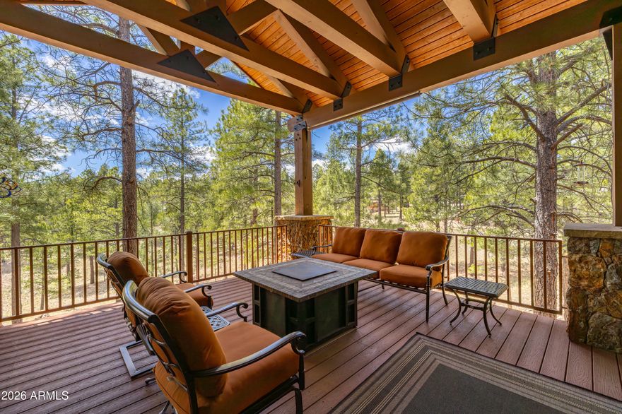 3460 S Del Aire CT, Flagstaff, AZ 86005. Luxury estate tucked into a private cul-de-sac within the exclusive Pine Canyon community. Designed for year-round living and unforgettable entertaining, this remarkable property combines luxury, privacy, and the beauty of Northern Arizona's forest landscape. Set on a .79-acre homesite, the estate backs to protected Pine Canyon open space with the Coconino National Forest beyond, while additional National Forest land sits directly across from the home's entrance. 
A charming front courtyard with lush gardens and a covered porch welcomes you home, while slate flooring at the entry offers both elegance and practicality for mountain living. Inside, the great room showcases a dramatic Telluride stone fireplace, soaring beamed ceilings, and warm wood finishes that create an unmistakable mountain-lodge ambiance. Expansive windows and direct access to the covered rear deck seamlessly blend indoor and outdoor living.


The chef's kitchen is thoughtfully designed for both everyday living and entertaining, featuring a large center island, breakfast bar, pot filler, gas cooktop, double ovens, dual dishwashers, warming drawer, beverage station, ice maker, prep sink, and walk-in pantry. Adjacent to the dining room, a temperature-controlled wine room with striking onyx flooring adds another layer of sophistication.

The main-level owner's suite offers a luxurious private retreat with its own fireplace, forest-view deck access, and spa-inspired dual bathrooms and custom alder wood closets. A spacious shared shower, jetted tub, premium slate finishes, and thoughtfully designed storage elevate the suite to resort-style living.

Also on the main level are a private office with built-in desks and forest views, a spacious laundry and mudroom, and a conveniently located guest powder bath.

The lower level is designed for entertainment and guest accommodations, featuring a large family and game room, wet bar, sauna, and an impressive tiered theater room with reclining seating and professional acoustic treatments. Four additional bedrooms provide comfortable guest space, including a private guest suite and bedrooms with patio access and spa-style baths. The fourth room is a bonus room currently being used as a bedroom. Five upscale bathrooms throughout include the ensuite primary bathroom, two powder room half baths, a full shared bathroom, and a full primary bathroom downstairs. 

The oversized garage configuration includes three full-size bays plus an additional half bay with separate access, offering exceptional flexibility for vehicles, storage, or recreational equipment. Custom iron fencing creates a secure dog run, and generous additional parking accommodates guests with ease.

Located within the guard-gated Pine Canyon community, residents enjoy access to an extraordinary mountain lifestyle. Optional membership opportunities provide access to championship golf, fitness facilities, clubhouse dining, resort-style pools, and family amenities including Trout Park, walking trails, playgrounds, concerts, sledding events, and more -- all just minutes from shopping, downtown Flagstaff, and Arizona Snowbowl.