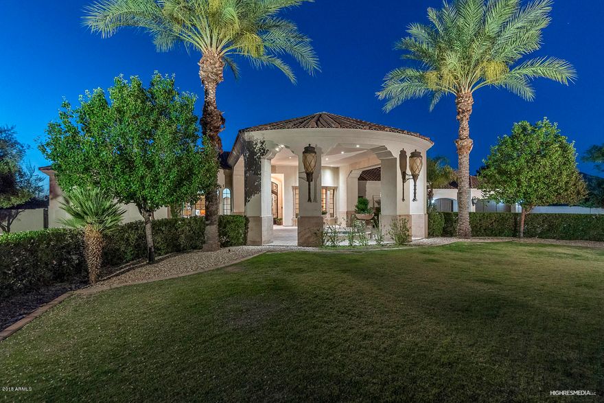 A rare find, this elegant estate in the popular Cactus Acres is on 1.1 acres of lushly landscaped grounds. The main home and separate guest home are adorned with finely selected finishes, hand-crafted cabinetry and doors, intricate ceiling details and a flowing plan with influences of modern Mediterranean architecture. A circular drive greets you with a water fountain and hand-forged iron and glass door that look through the formal living room's glass retractable wall to the resort backyard beyond. The formal dining room has an oval ceiling with crystal chandelier and looks into the 800+ temperature-controlled wine cellar through hand-carved wood arched windows. The great room is the heart of the home and is anchored by a Canterra fireplace, limestone floors with glass tile inlay,custom... A rare find, this elegant estate in the popular Cactus Acres is on 1.1 acres of lushly landscaped grounds. The main home and separate guest home are adorned with finely selected finishes, hand-crafted cabinetry and doors, intricate ceiling details and a flowing plan with influences of modern Mediterranean architecture. A circular drive greets you with a water fountain and hand-forged iron and glass door that look through the formal living room's glass retractable wall to the resort backyard beyond. The formal dining room has an oval ceiling with crystal chandelier and looks into the 800+ temperature-controlled wine cellar through hand-carved wood arched windows. The great room is the heart of the home and is anchored by a Canterra fireplace, limestone floors with glass tile inlay,custom built media center and wet bar with copper sink, two refrigerators and glass front cabinetry with accent lighting.

An African mahogany breakfast bar overlooks this WOW kitchen with large island and beautiful crafted cabinetry with generous storage, spice racks coffee bar. Top of the line appliances include multiple Sub-Zero refrigerator/freezers,  Wolf 60" 6-burner range with two full ovens and warming drawer, and Bosch and Fisher-Paykel dishwashers. The walk-in pantry has plenty of storage and pull out drawers. The separate oval-shaped breakfast nook offers built-in seating with kid-friendly fabric and overlooks the outdoor patios. 

Ready to have some fun? Check out the game room with two automated glass pocket doors and the full bar including two refrigerators, ice maker and dishwasher. Plenty of storage, three TV's, an arcade and powder bath make this the perfect place for your next sporting event.

When it's movie time, relax in the home theater with a large screen and projector, snack bar with microwave and two refrigerated drawers and powder bath, complete with mini TV, so you don't miss a thing. 

At the end of the day, relax in the master retreat with solid hardwood flooring, Canterra fireplace, wood beams and custom draperies. The spa bath includes a free-standing air jetted tub with back warmer and steam shower with rain head and body jets. The two large walk-in closets are perfect for those who love fashion and also has a second washer/dryer. 

Looking for large extra bedrooms? The en-suite guest room and two additional bedrooms are very spacious with walk-in closets and crown moulding. 

Let's get the party started! The entertainer's paradise outdoors is a treat for the eye. From the flames in the glass tile pool to the swim up bar, to the sport court, putting green or batting cage, there is truly something for everyone. Three fireplaces offer a variety of conversation settings and the fire pit perfect for your favorite s'mores. Travertine pavers flow into Canterra patios and the two outdoor kitchens offers plenty of space to cook up your favorite BBQ. 

Your guests will never want to leave the luxurious two bedroom, two bath guest house with family room surrounding a Canterra fireplace, breakfast area and kitchen with refrigerator, microwave and dishwasher. 

Are you a car enthusiast on top of it? You'll love the underground car vault, limo bay with service amenities such as dishwasher and ice maker, and car lift to accommodate your every whim. 

Come see for yourself.