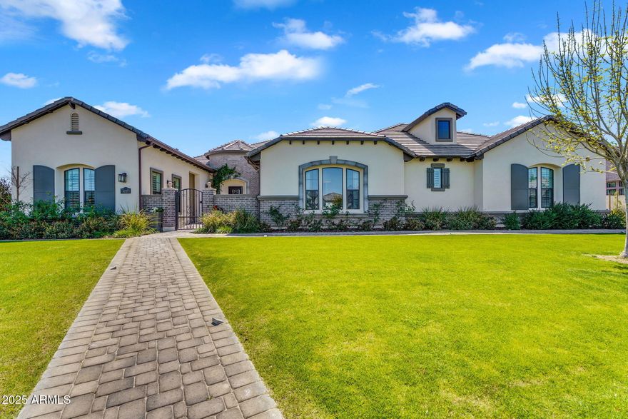 Welcome to a truly picture perfect home at the exclusive Estates at Hermosa Ranch, a premier gated community in north Mesa. This breathtaking 5247 sqft home, set on a 38,000 sqft lot, offers a seamless blend of sophistication, comfort, and state of the art amenities. Built in 2021, this five bedroom residence is designed for both grand entertaining and everyday comfort, with each bedroom featuring its own private ensuite that has been beautifully designed. Real plank hardwood floors flow throughout the entire house, no carpet! In the open living room you have an 18' sliding glass door, floor to ceiling custom cabinetry, and an impressive fireplace. At the heart of the home, the chef's kitchen is a masterpiece of form and function, featuring a Viking six burner stove with griddle and double ovens, a Sub-Zero refrigerator and freezer, two Scotsman ice makers, (cubed and the good sonic ice), two dishwashers, a warming drawer, a wine fridge, and a bar areaall designed to elevate your culinary experience.
Around the corner from the dining room is a secondary space that has rooms for a den, and a game room, playroom, or anything that works for you!
The luxurious primary suite also features a stunning fireplace, automatic shades, and a door leading right outside. The bathroom is spacious with 2 walk in closets with custom cabinets, and 2 separate sizable vanities.
Step outside to an entertainer's paradise, complete with a private pool with heater, in ground trampoline, garden area, and a pool house equipped with a half bath, wine and soda fridges, ice makers, a drawer dishwasher, and retractable power screens. The expansive outdoor living space is enhanced by a gas fire pit and a Savant whole-home audio and TV system, with speakers seamlessly integrated indoors, outdoors, and throughout the pool house, gym, fire pit, and front yard.
Car enthusiasts will appreciate the four-car garage plus an RV garage, that provides endless possibilities, like a home gym! The 5th bedroom has a separate entrance in the front courtyard area for your guests to enjoy.
With every detail thoughtfully curated for luxury and convenience, this remarkable estate offers the ultimate in modern living. Welcome to your dream home.