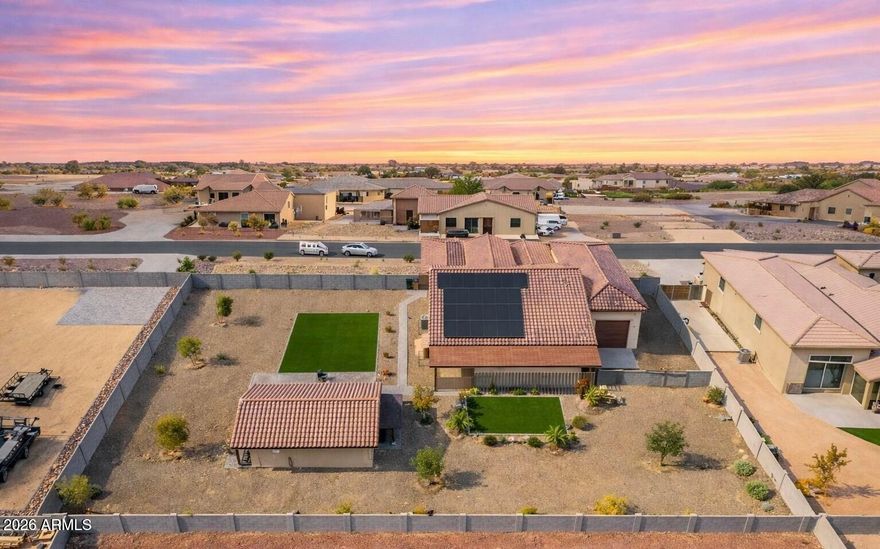 Set on nearly an acre of lush, manicured grounds in sought-after Luke Ranch Estates, this exceptional residence blends refined style & everyday comfort enhanced by a fully owned solar system for energy efficiency. From the moment you arrive, the impressive curb appeal & expanded cobblestone driveway hint at the thoughtful upgrades found throughout. Inside, a warm, inviting interior showcases a neutral palette, elegant Union Stone tile flooring, upgraded carpet in the bedrooms, 5¼'' baseboards, & custom blinds & window treatments. The spacious Great Room & Casual Dining Area are perfectly positioned to capture serene views of the beautifully designed backyard. The chef-inspired Kitchen is both functional and stunning, featuring 42'' cabinetry with dovetail, soft-close construction, sleek quartz countertops, an oversized island with bar seating & added storage, plus a premium Samsung stainless steel appliance package including a convection oven & upgraded induction cooktop. The Primary Suite offers a true retreat with a generous walk-in closet & a beautifully upgraded, enlarged shower with frameless 3/8" glass surround. Two additional bedrooms with walk-in closets, a versatile Office/Den (ideal as a formal dining space), & an expansive laundry room with abundant storage complete the main home. Step outside to enjoy seamless indoor-outdoor living. The extended covered patio, custom pergola, & paver walkways create multiple inviting spaces for relaxation & entertainment, all surrounded by low-maintenance landscaping with turf, trees, plants, & a full irrigation system. A standout feature of this property is the stunning ~750 sq ft Guest House, offering a private retreat complete with its own Great Room, Bedroom, full Bath, and a fully upgraded Kitchen with quartz countertops and Café appliances, including an induction cooktop. A spacious front porch with sunshades enhances comfort & privacy. Additional highlights include a 3-car tandem garage, an Extended, Fully Insulated and Temperature-Controlled 52-foot RV Garage, RV Parking, plus expanded parking. This one-of-a-kind property offers space, versatility, & upscale living, an exceptional opportunity not to be missed.