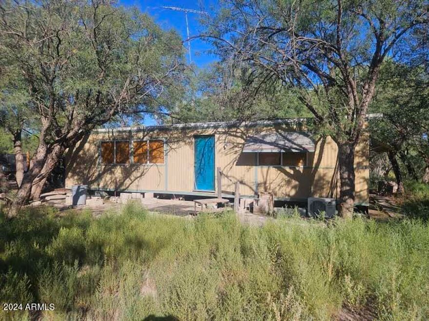 Rare riverfront property with the Babocomari River running through it.  20 acres of land with large mature trees and spectacular view of the mountain ranges.  Surrounded on two sides by public land this is a truly private and secluded location.  Water is provided by a private well and there is a two car garage and older manufactured home that can be remodeled.  Owner may carry.