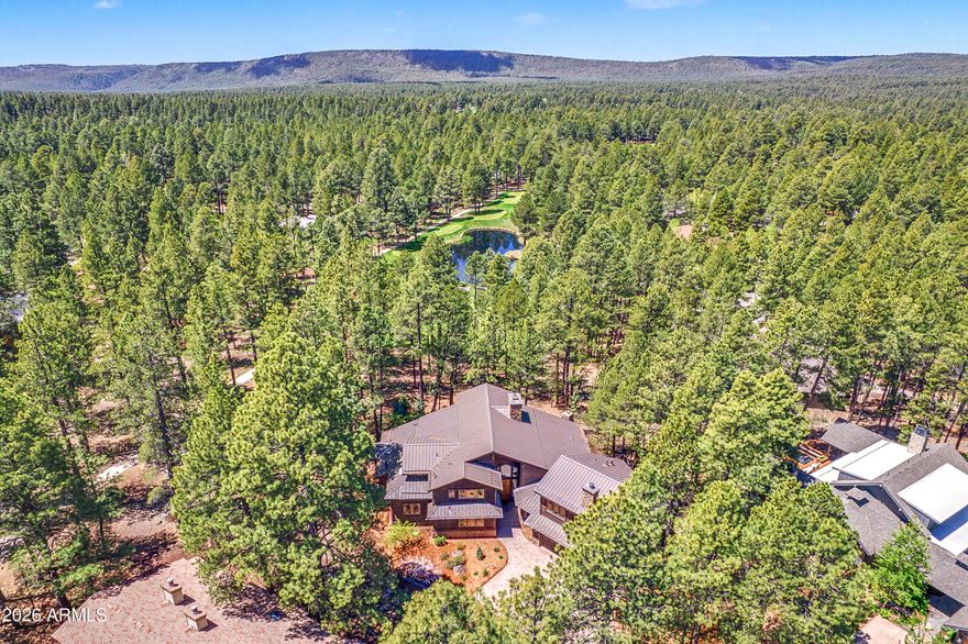Golf Course and Lake views!! Situated in a private cul de sac and perched above the 4th green of the Canyon course.  This home has all the spaces you need and outdoor living that takes in all the amazing views. The great room boasts a massive stone fireplace, wall of windows that frames the golf course and lake.  5 total bedroom suites with ensuite baths.  The Master suite, an additional guest suite and large office is on the main level and 2 additional guest suites upstairs.  The secret room is a large suite complete with wet bar, bedroom, bathroom and full family room.  Fully equipped open chef's kitchen with multiple islands. Top it off with beautiful landscaping, central A/C and a 3 car garage!