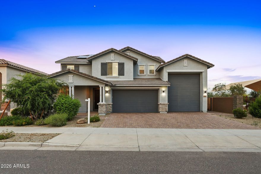 Assumable VA loan at just 5.125%! Luxury, views, and room for everything you love await in this stunning 4-bedroom + loft, 3-bath home offering 2,818 sq ft on a premium corner lot with no neighbors behind or to the side and unobstructed mountain views. Designed for both everyday comfort and elevated living, this property features a 5-car garage including a dedicated RV bay, and the owner spared no expense with over $182,000 in upgrades throughout.

Inside, you'll find gorgeous plank flooring, plantation shutters, and high-end finishes in every room. The open-concept layout seamlessly connects the kitchen, family room, and dining area, making it ideal for entertaining and daily.. living. The chef's kitchen is a true centerpiece with quartz countertops, subway tile backsplash, staggered soft-close cabinetry, a huge walk-in pantry, butler's area, and a large eat-in island with pendant lighting. The premium GE Café stainless steel appliance package -- including a 6-burner gas range and French door refrigerator -- completes the space beautifully.

The downstairs bedroom and full bath are perfect for guests, a home office, or multigenerational living. Upstairs, the split primary suite feels like a private retreat, featuring a spa-inspired bath with a soaking tub, custom tile surround, dual quartz-topped vanities with Kohler sinks, and an oversized shower with rain and handheld heads, bench seating, and tile to the ceiling. The walk-in closet is equally impressive. Two additional spacious bedrooms, an upgraded full bath, an oversized laundry area, and a versatile loft provide flexibility for a playroom, media room, office, or lounge space.

The low-maintenance backyard was built for entertaining and relaxing, with paver patios, artificial turf, solar lighting, and view fencing that perfectly frames the mountains. Enjoy unforgettable evenings around the sunken fire pit lounge, or host with ease from the raised outdoor kitchen featuring a Turbo 4-burner stainless steel grill, refrigerator, sink, and custom backsplash. The covered patio with ceiling fan and TV mount completes the outdoor living space.

Bring all your toys -- this neighborhood was built with RV living in mind, and each home in the immediate area includes a dedicated RV garage. The epoxy-coated 3-car tandem garage plus the massive RV bay with cleanout and 60-amp service gives you space for up to 5 vehicles, an RV, boat, UTVs, side-by-sides, storage, and more. Additional functional upgrades include an RV dump/cleanout, overhead storage, a cleanup sink, and a soft water system.

The 14kW solar system is fully paid off and will convey to the buyer at closing, delivering major energy savings and dramatically offsetting APS bills. The seller is happy to provide the last 12 months of electric bills -- they are impressively low. This is a rare opportunity to own a home that blends luxury, function, efficiency, and lifestyle in one exceptional package.