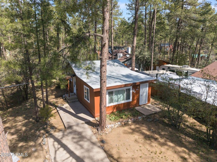This adorable 2 bedroom, 1-bath cabin is the perfect summer retreat! Recent updates include a new roof, interior/exterior paint, updates to plumbing, electrical panel, kitchen, bath, flooring, and new mini-splits for AC/heat. Small garage is perfect for your ATVs, snowmobiles, or extra space for storage. Larger lot with lots of trees for shade! Established in 1884, Ponderosa Park in Prescott, Arizona, is a charming and picturesque community nestled in the heart of the Prescott National Forest and only 5 miles from downtown where you can enjoy the famous Whiskey Row nightlife, excellent restaurant, shopping and entertainment. Known for its serene, forested landscape, Ponderosa Park offers residents a tranquil retreat surrounded by towering pine trees and abundant wildlife. This area is perfect for those who love outdoor activities such as hiking, mountain biking, and wildlife watching, with numerous trails and natural beauty at every turn. It can be sold furnished as well. Don't miss out on this unique opportunity, come see it today!