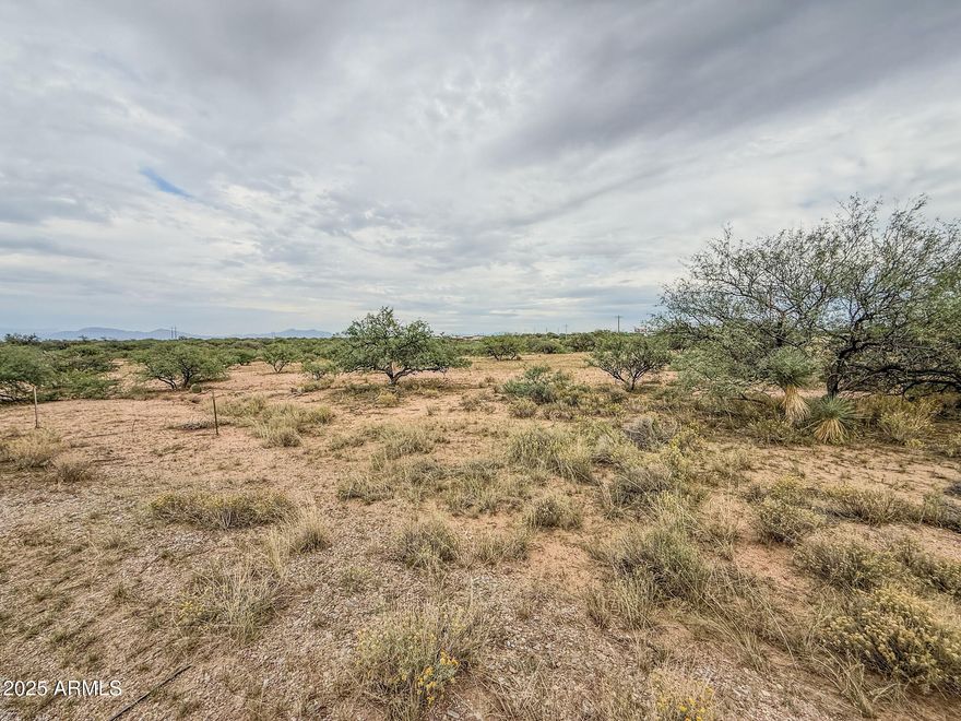 Discover 5+ acres of wide-open space just west of Benson, offering the perfect blend of rural tranquility and convenience. This level, usable parcel provides plenty of room for your dream home, horses, or hobby ranch—with beautiful 360-degree mountain views and stunning Arizona sunsets. Located just off Tequila Trail, the property offers easy access to I-10 for a quick drive to Benson or Tucson. Power is nearby, and there is abundant space for a private well and septic system. Experience peaceful country living with the freedom to create your ideal desert retreat!
The property is a 5.7-acre portion of 12406005B—survey to be recorded at closing.