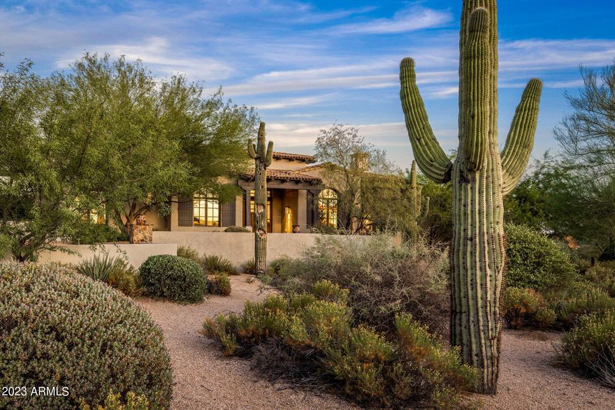 Very attractive ranch style home located on an elevated corner lot in the guard gated Mirabel Club community. This desirable floorplan boasts 4000 sq. ft. with 4 Bedrooms, office, 4 1/2 bathrooms & an oversized 3 car garage large enough for 3 cars plus a golf cart. One of the guest suites is a full mini-primary with a soaking tub & separate shower, dual sinks and walk-in closet. The home has many interesting ceiling details including massive beams in several rooms and an intricate brick groin vault in the entry foyer. Updates include new custom cabinetry and updated light fixtures. A large pocket door opens the great room up to the spacious backyard with an infinity edge pool, spillover spa, outdoor kitchen and putting green. Views of Pinnacle Peak and McDowell Mountains from the backyard