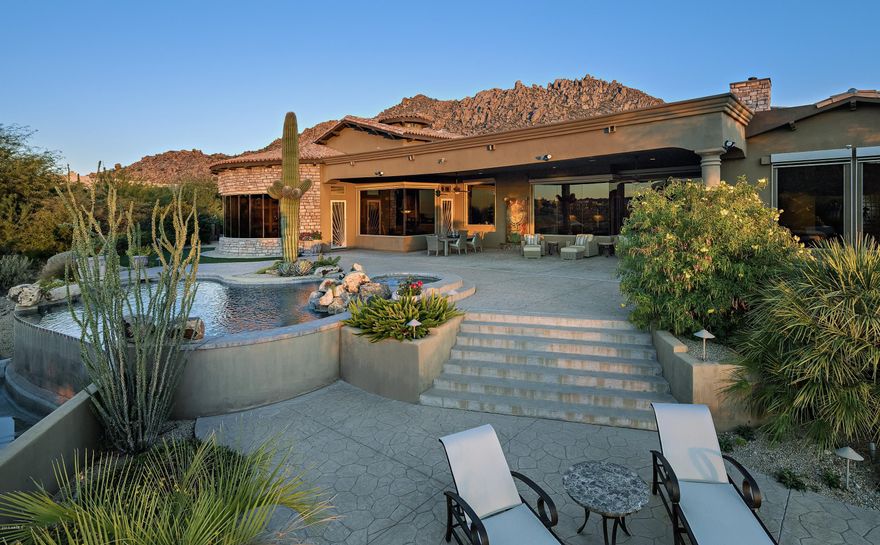 Magnificent Soft Tuscan-Style Estate offers spectacular panoramic views of the Surrounding area including the Mcdowell's and Troon Mountain plus the primary bulls eye view of Pinnacle Peak along with city lights, and last but not least, is one of the best Sunset Properties in North Scottsdale. Located in the guard gated community of Windy Walk Estates in Troon and situated on the 8th fairway of private Troon Country Club this 6,691 sq. ft. 5 bedrooms 5.5 bathroom home features an impressive open floor plan with high volume ceilings and the most grandious great room in the area including a Gourmet kitchen with large u-shaped kitchen island and featuring stainless appliances, custom wood cabinetry and granite counter tops which opens to the family room and is perfect for entertaining. Formal dining and living room open to a wet bar with wine fridge and icemaker. Office, flex/den room and 2 bedrooms are all spacious en suite with large walk-in closets.  Master suite with sitting area and fireplace, spa-like bath, dual vanity sinks, soaking tub, steam shower, his/her water closets and custom walk-in closet. Outdoors youAll find heated pool and spa, expansive covered patio, built in BBQ, fireplace and 2 separate sitting areas to breathtaking views. Separate laundry, 4-car garage with large storage room. This truly is an entertainers dream home to enjoy and be stunned by spectacular views.