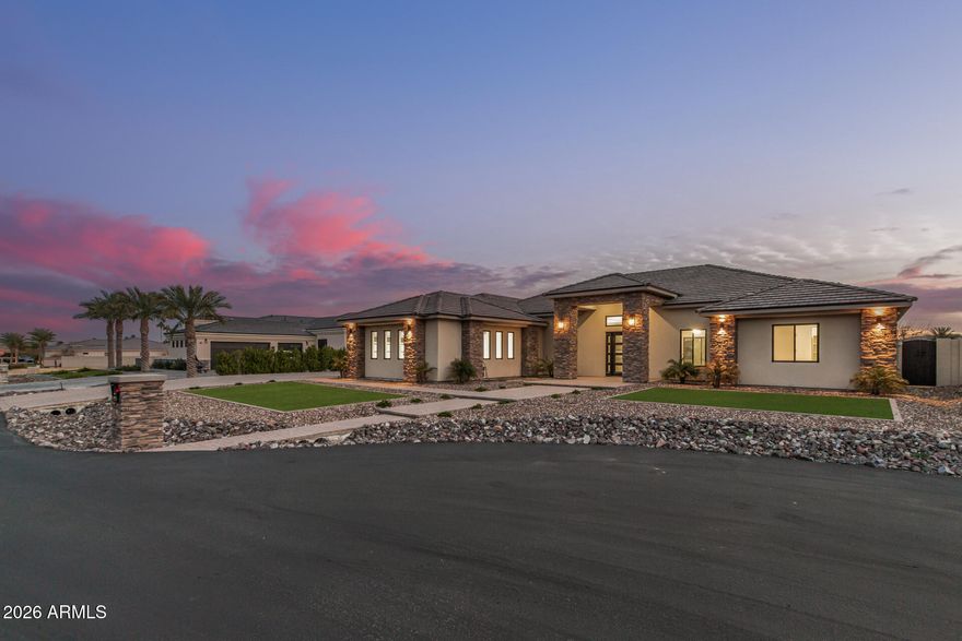 Exquisite single-story estate built in 2025, situated on a private 0.38-acre cul-de-sac lot within the gated Russell Ranch community. Offering approximately 3,569 sq ft of thoughtfully designed living space, this home features 4 bedrooms and 5 bathrooms, each with spa-inspired ensuites and custom walk-in closets. The open-concept floor plan is filled with natural light and showcases soaring ceilings, tile flooring throughout, and an elegant living area highlighted by an electric fireplace with custom mantel. The chef's kitchen is designed to impress, featuring a massive quartz island, custom cabinetry with under-cabinet and glass-front LED lighting, double wall ovens, gas range with pot filler, stainless steel appliances, walk-in pantry, butler's kitchen, and wine and beverage coolerideal for both everyday living and entertaining.

The private primary suite is a serene retreat, thoughtfully separated from the secondary bedrooms, and offers French doors to the backyard, a spa-like bath with a free-standing soaking tub, oversized walk-in shower, private water closet, and a luxurious custom-designed walk-in closet. Additional highlights include a bonus/game room, fire sprinkler system, ceiling fans in every room, a data-ready cabinet prewired for whole-home WiFi and exterior cameras, and a 400-amp electrical panel with a 200-amp sub panel pre-wired for an EV charger.

Car and RV enthusiasts will appreciate the 3-car garage plus a 20 ft x 45 ft drive-thru RV garage that is fully climate-controlled with air conditioning, featuring 50-amp electrical service, a 14 ft front RV door, a 10 ft rear drive-thru door, and a convenient half bath, along with a spacious paved driveway.

 The exterior features low-maintenance desert landscaping with synthetic turf and a large block-fenced backyard ideal for entertaining. Located in a gated community with a children's playground and convenient access to schools, shopping, and amenities, this exceptional home blends modern sophistication with resort-style living.