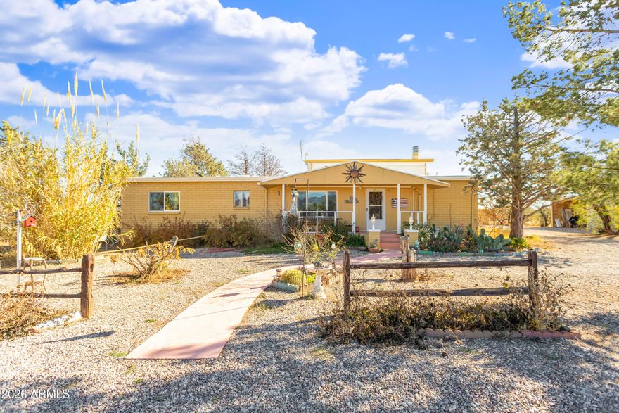 Off a paved road!! Lots of upgrades on this **manufactured home with additions** 5 acres ready for your horses.  Fenced and cross fenced. 3 bedrooms and 2 bathrooms. Split floor plan with bonus room upstairs and an Arizona room. Nice work shop w/ indoor access. Large 2 car carport and a 26X11X12 RV carport. 37X8 pole barn w/ a pipe panel corral for horse with inner corral plus tac room. Fully enclosed indoor pool. Lots more!!!
