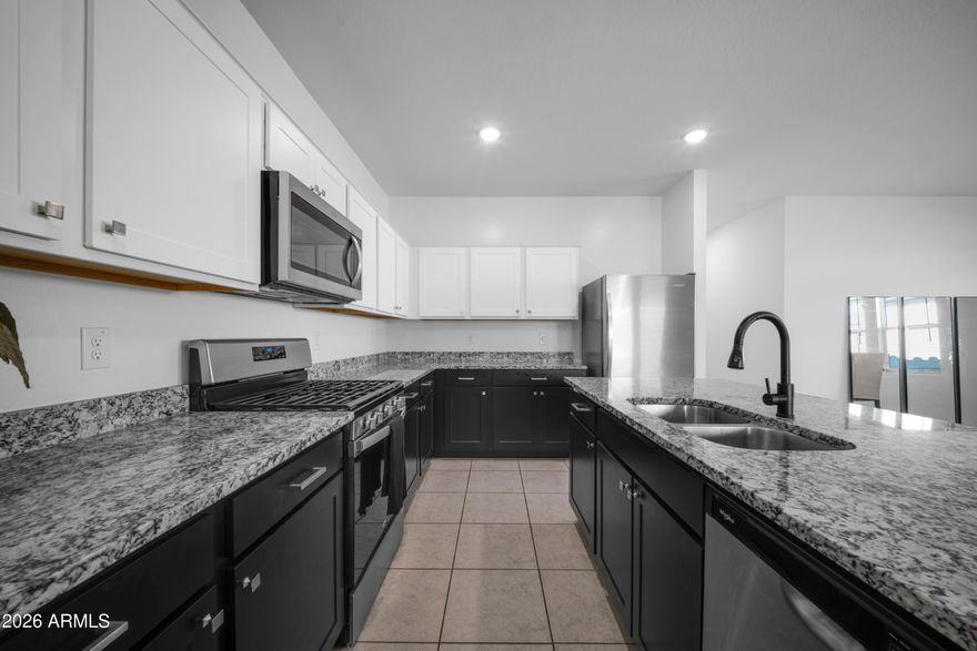 Welcome home to this beautiful, move-in-ready single-story residence in the heart of Laveen! Boasting a highly desirable open-concept floor plan, this 4-bedroom, 3-bathroom home offers the perfect blend of comfort and style. The spacious kitchen flows seamlessly into the main living area, making it ideal for entertaining family and friends. Relax in the private primary suite featuring a generous walk-in closet and en-suite bath. Step outside to a low-maintenance backyard blank canvas ready for your personal touch. Located in a fantastic community featuring pristine greenbelts and neighborhood parks, with quick access to the Loop 202, local dining, and shopping. Don't miss this Laveen gem!