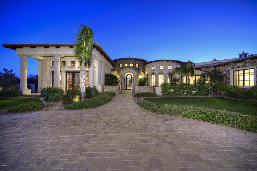 Stunning Mediterranean gated estate w/ Camelback Mtn views in this quiet, tucked away location boasting outstanding architectural design features & highly upgraded finishes! Amazing interior finishes include very custom Clive Christian cabinets throughout the home.  The chef's kitchen is exquisite in detailing & design & boasts a fabulous Sub-Zero/Wolf/Asko appliance pkg that is 2nd to none!  Buyers will love the open floor plan & soaring high ceilings throughout the home & the stunning automated wall of glass in the great room that opens to a sunny south facing resort style backyard is over the top w/ fabulous Camelback Mtn views & an A+++ huge wet edge pool/spa w/ extensive water features & lush landscaping---truly like living at your own 5-Star resort! The split floor plan is ideal for privacy for the owners w/ the decadent master suite & beautiful formal office at 1 end of the home & the kids' wing & media room at the other end of the home.  The master suite is impressive in size & elegance.  It features the same stunning Camelback Mtn views as the formal living room & kitchen & great room--truly significant.  The master bathroom features marble & ebony wood floors & a magnificent master jetted tub & sep. shower + 2 spacious sep. HIS/HER walk-in closets ---all boasting the custom Clive Christian cabinetry! There are elaborate groin vault ceilings in the main foyer & grand hall way & 3 gorgeous fireplaces w/ canterra stone surrounds that feature many beautiful corbels.  There is a sep. guest house   that will delight your visitors--w/ it's own family rm, featuring a canterra stone fireplace & sep. master suite & bathrm---they won't want to leave!  All secondary bedrooms are ensuite w/ large walk-in closets & stunningly beautiful private bathrooms. Total sf combined main house & guest house -8956 sf.