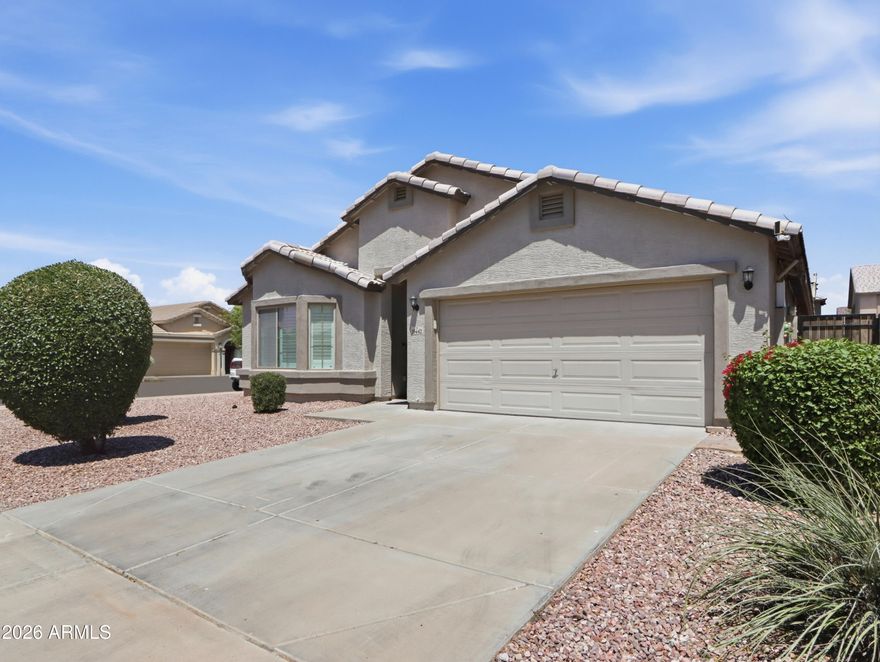 Beautiful North/South corner-lot home in Tolleson with great curb appeal and low-maintenance landscaping. Bright, airy interior features vaulted ceilings, abundant windows with wood shutters, and flexible formal living/dining space. Spacious kitchen offers stainless steel appliances, granite counters, ample cabinetry, and room to entertain. Large family room includes TV mount. Split primary suite fits oversized furniture, with bay window and ensuite featuring separate shower, garden tub, and dual sinks. Secondary bedrooms are roomy with updated bath. Backyard includes covered patio and space for a pool. Extras: new HVAC, newer water heater, RO system, EV charging, solar, indoor laundry. Near I-10 & Loop 202, parks, shopping, dining.
