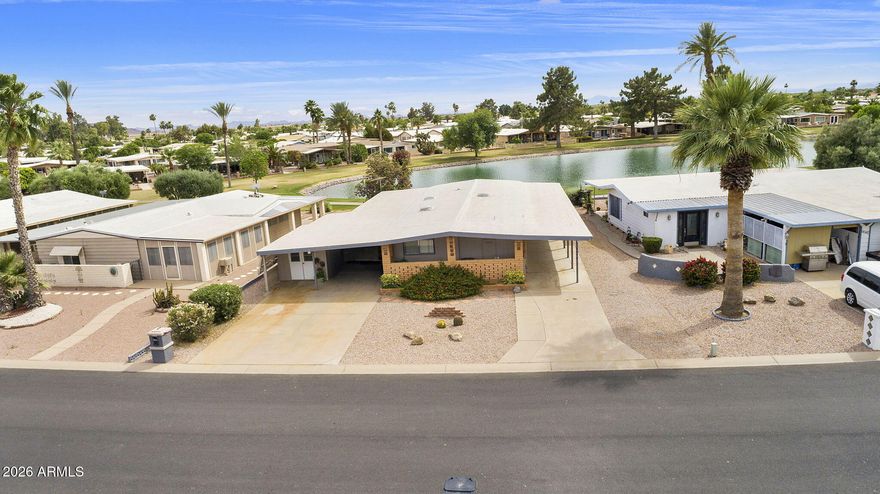 Location is everything in this 1998sf 3BR, 2BA charmer with amazing water views on the serene walking path in the active adult community of Sun Lakes Country Club. Great room with laminate flooring an two giant windows looking out at one of the community lakes. Efficient kitchen with ample storage and counter space, white appliances and a cozy breakfast nook. Enormous bonus family room could be a game room or crafting room. Good sized primary suite with walk-in closet and raised vanity. Tons of storage space in this rare find. Full covered carport on one side and extra covered parking and golf cart garage on the other side. Roof recoated in 2022, AC 2010. Come enjoy the amenities of Sun Lakes Country Club with pools, tennis, golf, pickleball, restaurants and countless clubs.