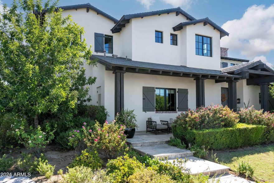 Welcome to Arcadia Parkside, an exclusive gated enclave of four exquisite homes in the highly sought-after Arcadia neighborhood, just steps from Arizona Country Club and local hotspots. This stunning residence features lush landscaping and a well-designed floor plan spanning nearly 4,000 square feet. The chef's kitchen boasts a spacious island and top-of-the-line appliances, ideal for culinary enthusiasts. Soaring ceilings create an impressive atmosphere, while reclaimed wood beams, French oak flooring, and custom millwork add warmth. The exceptional primary suite offers a luxurious soaking tub, oversized shower, and a generous walk-in closet. The backyard is an entertainer's dream, with ample patio space, lush landscaping, and a sparkling pool. Experience the perfect blend of sophistication and tranquility at Arcadia Parkside, where every detail has been thoughtfully curated for a luxurious lifestyle.