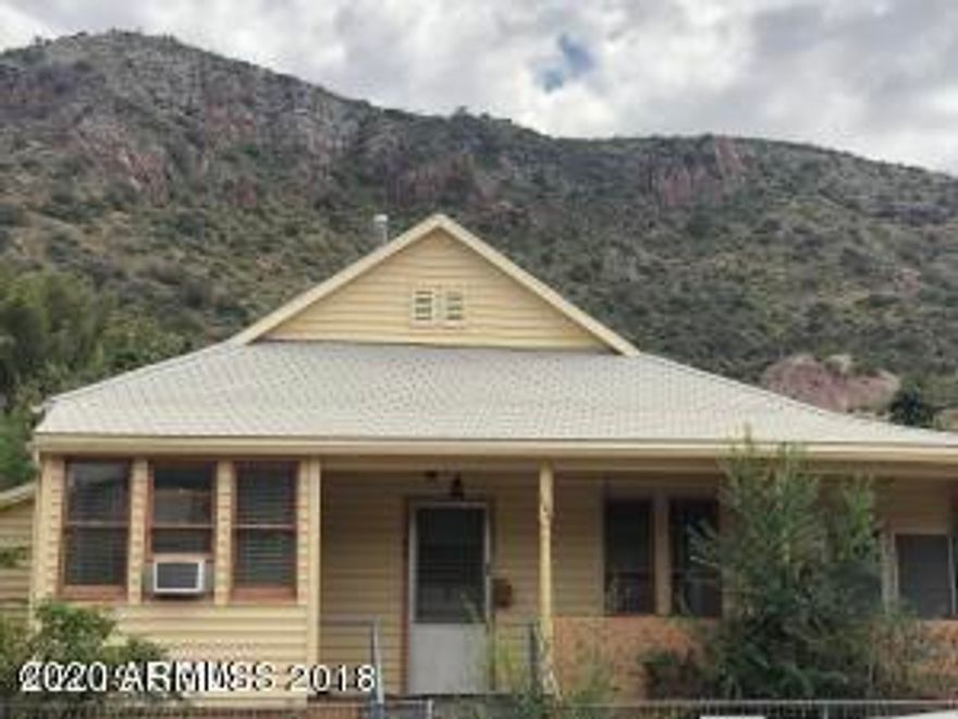 Great little home on corner lot just 7 steps from the street located in historic Old Bisbee. Perched up on the hill, this home on Quality Hill has beautiful panoramic views of Castle Rock and B Hill. Built in 1901 this 2bed/2bath home has large bay windows, plant shelves and skylights. Garage on separate tax parcel with electricity provides extra storage. Don't miss this great opportunity! Stop by and see it today!!