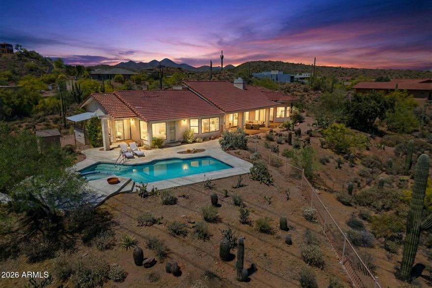 VIEWS, VIEWS, VIEWS! This true and unique gem, meticulously renovated and remodeled throughout, offers unobstructed and infinite views just waiting to be discovered. This thoughtfully designed 3,376 sq ft home, situated on 1.6 acres in prestigious Firerock Estates, offers a luxurious lifestyle and truly feels like a piece of desert paradise. With practically everything new, you'll appreciate the attention to detail. The heart of the home features an open, airy living space with soaring ceilings and an impressive floor-to-ceiling stone wood-burning fireplace. A second kiva-style fireplace crackles in the cozy, adobe-style den. Large picture windows and sliders provide natural light and seamless access to outdoor living. The gourmet kitchen, a chef's delight, features elegant white quartz countertops and sleek light wood cabinetry. The spacious master suite offers a true retreat with a dedicated sitting area and a spa-like bathroom. Oversized 2.5 car garage. Outside, your private oasis awaits. A sparkling pool and spa offer resort-style living against iconic desert and mountain views. Enjoy spectacular Arizona sunsets from your patio. Plus, for your peace of mind, the roof is only 2 years old and comes with a transferable warranty.