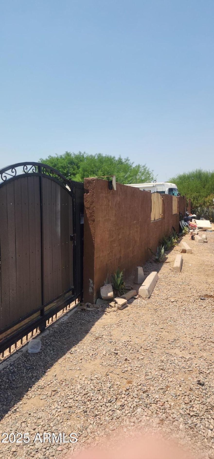 GREATLY REDUCED!!.24 acres allows two mobile homes on property or one mobile and one stick built. Currently has small mobile home (Freedom 1971 12x40 ) on permanent foundation on this large, fully enclosed lot.  Total electric, but gas is available. Has Electric cooktop, Electric wall oven, Stainless Steel appliances, new  mini-split a/c, electric water heater, washer/dryer included.  On Septic, City water, APS electric. Don't miss out on this gem!