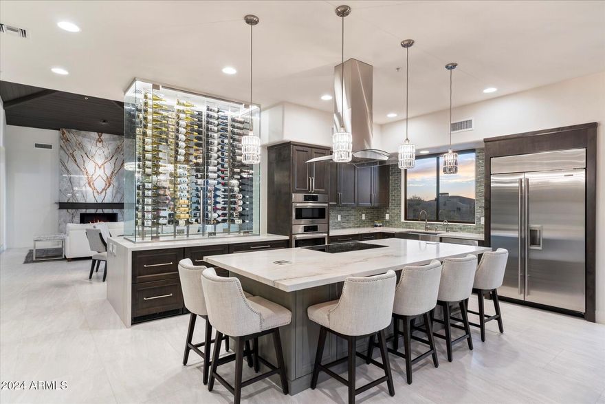 Exquisite Desert Retreat in the Prestigious Desert Mountain Golf Community

Nestled in the highly coveted Desert Mountain golf community, this impeccably remodeled residence offers an exceptional blend of modern sophistication and contemporary design. Completed in 2022, the home showcases clean architectural lines, a timeless color palette, and luxurious finishes throughout. A state-of-the-art kitchen serves as the heart of the home, featuring a striking 288-bottle glass wine rack and a grand island with an induction stove, perfect for both casual gatherings and formal entertaining. Premium quartzite and marble accents complement the stone-grain tile floors, creating a cohesive and refined aesthetic.

The private backyard is an idyllic sanctuary, offering panoramic mount views and the perfect setting for outdoor living. A sparkling pool and jacuzzi, along with a built-in barbecue, provide an entertainer's paradise. The natural desert landscaping ensures a low-maintenance lifestyle, ideal for the discerning lock-and-leave homeowner.

A detached casita adds flexible living space, offering privacy for guests or an opportunity for a home office. The expansive living areas and well-appointed guest suites create an inviting atmosphere for entertaining or simply relaxing in comfort. The serene primary suite is a true retreat, featuring a spa-like bathroom with a luxurious steam shower.

With its blend of high-end design, functional living spaces, and unparalleled desert vistas, this turnkey home represents the pinnacle of desert luxury living. Perfectly positioned to take full advantage of the Scottsdale lifestyle, this residence offers a rare opportunity to experience the finest in desert mountain living.