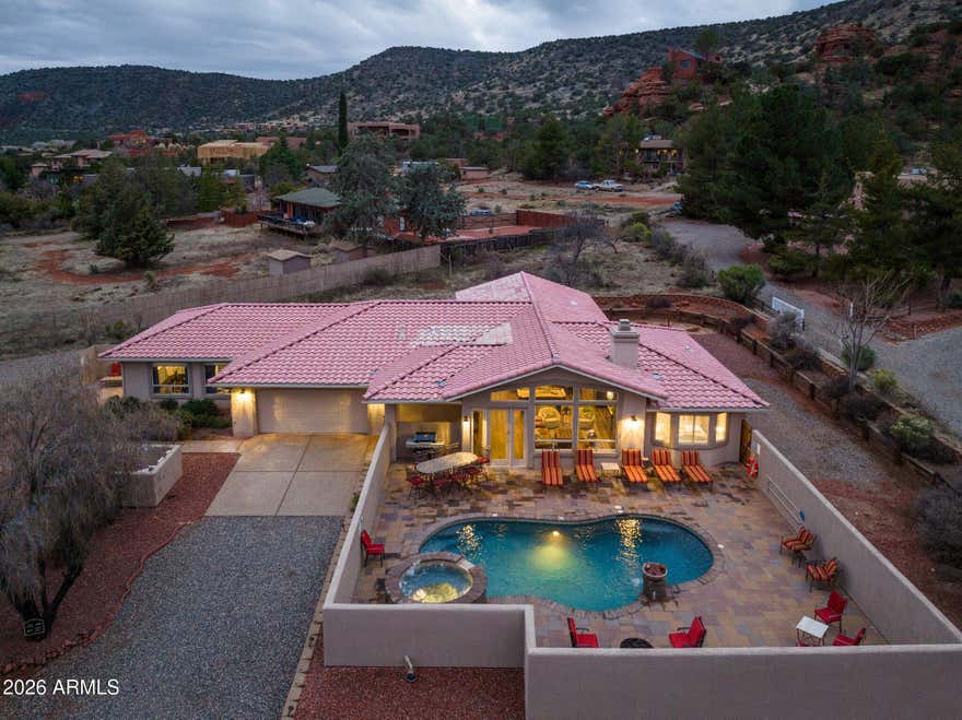Rare Opportunity: Highly active and consistently booked short-term rental located on a county island in a prime Sedona setting. This single-level residence offers 5 bedrooms and 4 bathrooms, situated on 1.3 private acres with unobstructed, breathtaking Red Rock views. The home is offered turnkey and fully furnished, including all linens, making it ready for immediate ownership and income generation.
The property has been recently updated with new flooring, new appliances, fresh interior paint, and curated Pottery Barn furnishings and décor. A private saltwater pool, an especially rare feature in Sedona that provides year around rentals  Additional highlights include a private guest casita and a spacious open-concept floor plan ideal for bot entertaining and relaxation. Generous on-site parking accommodates multi-generational groups and larger gatherings.
An immediate value-add opportunity is available with a fully permitted, architecturally matching 3-car garage measuring 24' x 38', ready for build-out and offering potential for additional living space, storage, or enhanced rental appeal. No HOA restrictions. The property continues to secure daily bookings and is well-positioned for immediate rental income.
Conveniently located near grocery stores, premier golf courses, dining, and renowned hiking trails.