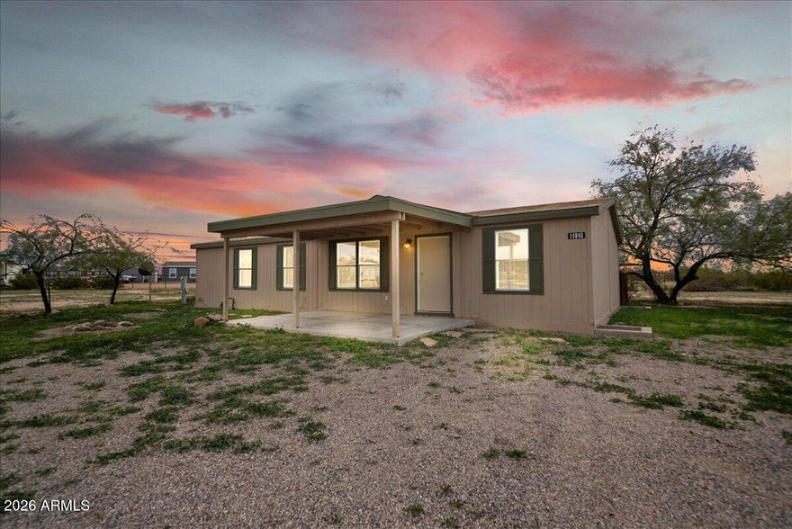 Welcome to Florence Homestead, the electronic gate welcomes you to this fully fenced horse friendly compound! Situated on 1.26 acres in Florence, AZ, s 1,344 square feet of comfortable living space, fresh interior paint with 3 bedrooms and 2 bathrooms. The open great room floor plan provides a functional layout for everyday living and entertaining. The kitchen features granite countertops and flows into the main living area, while tile & wood flooring throughout adds durability and easy maintenance. Zoned as horse property and includes an existing horse arena. The expansive lot offers plenty of space for animals, RVs, trailers, workshops, or future improvements. Enjoy privacy, open desert surroundings, and the freedom of rural living with convenient access to town amenities.