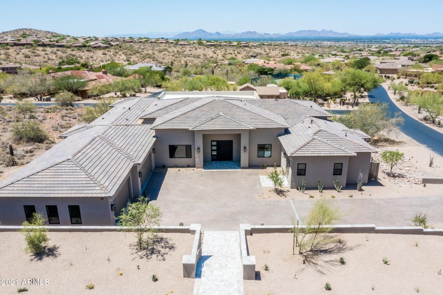Custom spec build in The Retreat at 100 Hills of MMR. Enter thru the 8'x8' impressive pivot steel door into this single story transitional contemporary gem. Feast your eyes on an ideal great room w/ gorgeous wood beams,13.5' ceilings, a double island in kitchen adorned w splendid finishes, a 24 x 10' sliding glass wall to back patio, 5 ensuite bedrooms including a wide-ranging flex room & an attached casita w/ exterior French door access, 5.5 baths, dedicated dining, study, drop zone & laundry as well as an oversized 4 car garage. Control4 smart home automation throughout. The backyard is stunning w/ an expansive covered patio, 2 sided infinity pool, waterfall spa, decorative firepit, BBQ station & artificial turf area all overlooking Camelback Mtn & the city below.