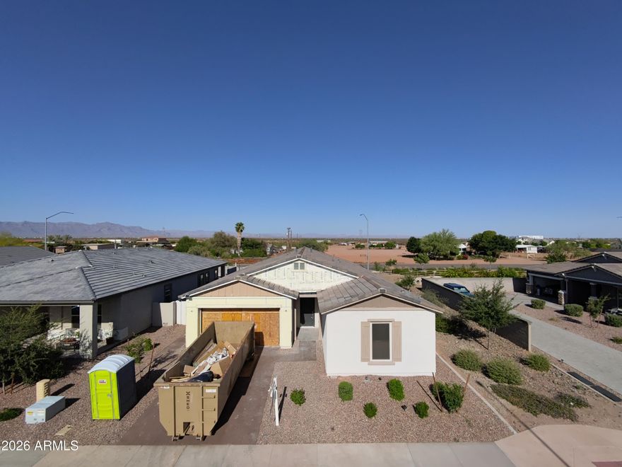 Welcome to a rare opportunity to personalize a nearly brand-new home in one of East Mesa's fastest-growing areas. This 4-bedroom, 3.5-bath home offers buyers the chance to create a custom feel without the extended timeline, uncertainty, or limitations of a traditional new build. Currently under reconstruction and rebuilt down to the studs, nearly every major component of the home is brand new, including the roof, insulation, drywall, HVAC system, water heater, and more. The attic has also been upgraded with foam insulation for enhanced energy efficiency and comfort beyond standard builder specifications. Unlike most builder spec homes where finishes have already been selected, this home gives buyers the unique opportunity to personalize many of the interior selections based on the current stage of construction. Buyer will have the ability to choose flooring, cabinetry, countertops, paint colors, lighting, accent walls, additional canned lighting, garage epoxy colors and finishes, and other custom design features to match their own style and vision.

Situated on a premium corner lot with only one direct neighbor and backing to a wash for added privacy, the location itself is hard to beat. The home also features a desirable 3-car tandem epoxy garage, permanent exterior lighting installed around the home, a soft water system, reverse osmosis system in the kitchen, and a backyard already designed for entertaining with low-maintenance turf, two pergolas, and an above-ground hot tub, saving buyers both time and significant post-move-in expenses.

This rapidly growing East Mesa corridor continues to attract attention for its convenience and future development. Located just minutes from the Loop 202, US-60, and SR-24, the home offers easy access throughout the Valley while remaining close to highly rated schools, parks, dining, and everyday amenities. Just a few miles away is the Arizona Athletic Grounds sports and entertainment complex, with additional major retail, luxury restaurants, hotels, shopping, and entertainment developments already planned nearby, making this an exciting opportunity to invest in an area with tremendous future growth

Additional bonus: seller currently has an assumable VA loan at 4.99%, creating a valuable financing opportunity for qualified buyers.
