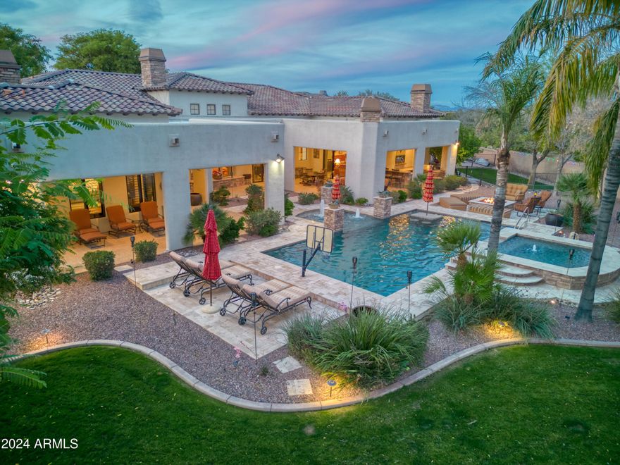 Your dream home awaits on this over 1-acre lot located at the end of a cul-de-sac in the desirable gated Estados of Circle G. Truly LUXURY from the inside out. Retreat to your own oasis backyard with lighted tennis court that can easily be converted to pickle ball also basketball court, mini golf course with 3 chipping pads, 2 large sand traps, built in BBQ, TV's, all why overlooking a heated sparkling saltwater pool & spa alongside a gas fire pit area to enjoy a cozy night in. State of the art Sonos & WI fi system interior/exterior. The inside does not disappoint, this over 5500sq' 4BR 6 BA home boasts a large home theater /game room with 110'' black diamond screen, Epson projection screen and Sony surround sound system, pool table, shuffleboard with its own beverage fridge, no need to go out, can enjoy family fun night in the luxury of your own home. The gourmet kitchen features Wolf appliances, gas stove top, 2 ovens, walk-in pantry, a walk-through coffee bar area, just around the corner is a separate wine room with large capacity wine fridge. The Master retreat has a cozy fireplace, large walk-in closet with custom shelves & lots of hanging area, also your own washer/dryer. All bedrooms include their own private en suite bathrooms and walk in closets. Wood shutters & solid wood doors throughout. Beautiful mature trees to offer lots of shade, separate gated dog yard. Enormous 4 car extended garage with air-conditioned workshop and lots of storage cabinets, huge driveway for plenty of guest parking, large rolling RV gate. The attic is equipped with a motorized lift with a large walk-in area to store all your Xmas decor. 3 new A/C systems 2023, new pool pump & salt system 2023, interior of home & exterior block wall has been sealed for scorpions. Fully secured by ADT security system and cameras on all doors, driveway, and yard.
All of this and still there's more! Enjoy the country club lifestyle with Seville Golf & Country Club, you can ride your golf cart over to enjoy a day of golf, or family fun with 4 pools, water slides, tennis, pickle ball restaurants & more!! 
For info on the country club lifestyle please visit Seville Country Club.
