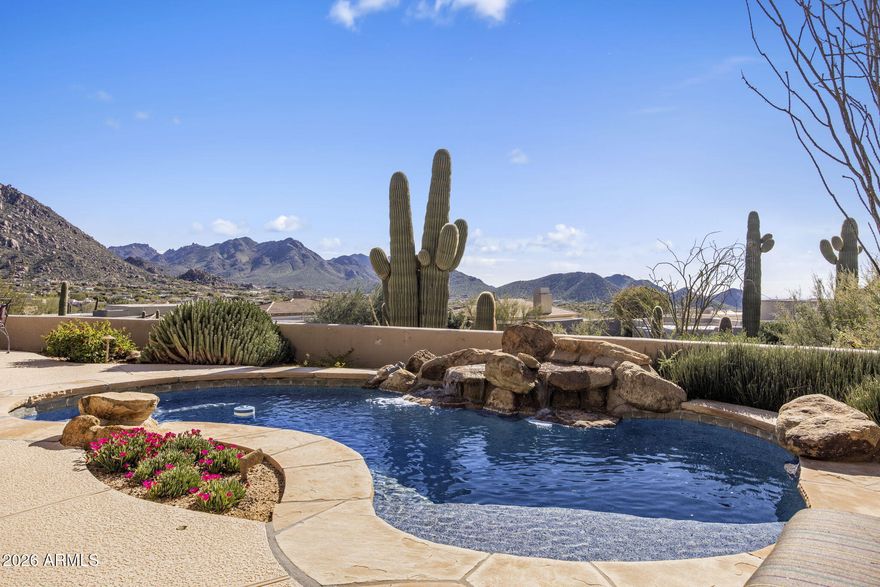 **Immediate Full Golf Membership Available at Closing**  Nestled at the base of iconic Pinnacle Peak, this extraordinary one-of-a-kind custom single-level residence offers sweeping mountain silhouettes, glowing sunsets, and shimmering city light views from nearly every room. Designed with no interior steps and an open, light-filled floor plan, the home effortlessly blends refined elegance with comfortable desert living; ideal for the most discerning luxury buyer.  
At the heart of the home is a chef-inspired gourmet kitchen featuring a gas cooktop, oversized walk-in pantry, and seamless flow into the dramatic great room. Here, warm wood beam accents, a cozy fireplace, and floor-to-ceiling windows and doors frame breathtaking valley vistas and create a stunning setting for both **Immediate Full Golf Membership Available at Closing.**
intimate gatherings and grand entertaining. A temperature controlled 1,600-bottle wine room adds a rare and impressive touch.  The owner's suite is a private retreat, where you'll wake to serene sunrise views and unwind by the fireplace while enjoying panoramic mountain and city light scenery from bed. The spa like bath offers dual vanities, a jetted soaking tub, an expansive walk-in shower, and dual walk-in closets designed for comfort and indulgence.  Three additional versatile guest bedrooms provide flexibility for visiting family and friends, private guest suites, or an elegant home office or den. Every detail of this residence has been thoughtfully curated to enhance flow, function, and luxurious living.  Step outside to a sun-drenched south-facing backyard showcasing jaw-dropping mountain views, unforgettable sunsets, and sparkling city lights. The resort-style spool is perfectly sized for cooling off on warm days or heating up for evening relaxation, complete with spa jets. Enjoy tranquil desert evenings by the firepit, or entertain alfresco with a built-in BBQ and sink an ideal setting for Arizona living at its finest.  Ownership in Desert Highlands includes unmatched privileges, highlighted by an **immediate Full Golf Membership**. Residents enjoy a private 18-hole Jack Nicklaus Signature Golf Course, an 18-hole par 42 putting course designed by Gary Panks, 13 impeccably maintained tennis courts (grass, clay, and hard), 4 pickleball courts, Bocce courts, dog park, stocked fishing pond, a state-of-the-art fitness center, multiple dining venues, and the peace of mind of 24 hour guard gated security.  This is a rare opportunity to own a truly exceptional Scottsdale retreat perfect as a luxury second home or primary residence in one of Arizona's most prestigious golf communities.