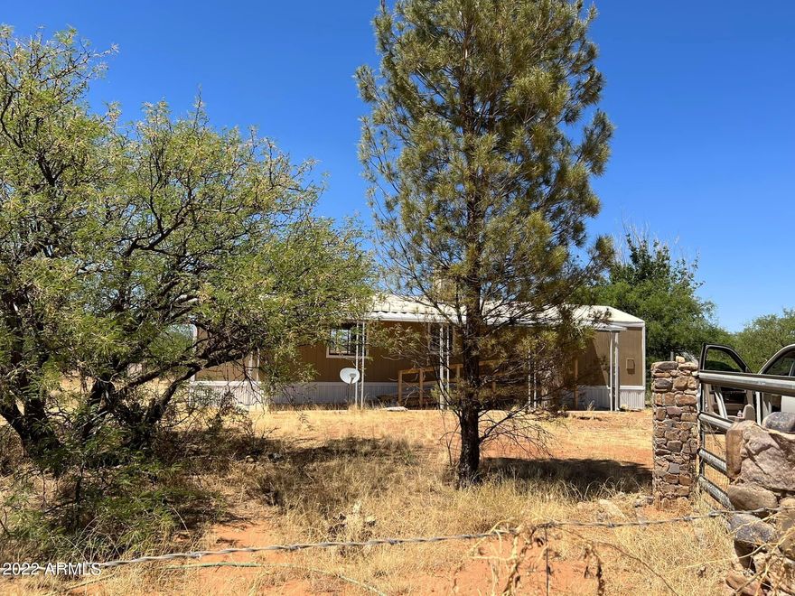 Private location. Mature trees, Fenced 4.5 acres, outside barn on property. 1 and half mile from San Pedro River  with 2bd 1 bath manufactured home. Well share, septic and electric. RV hook-ups, RV Gate. 
Fixer-Upper. Being sold as-is