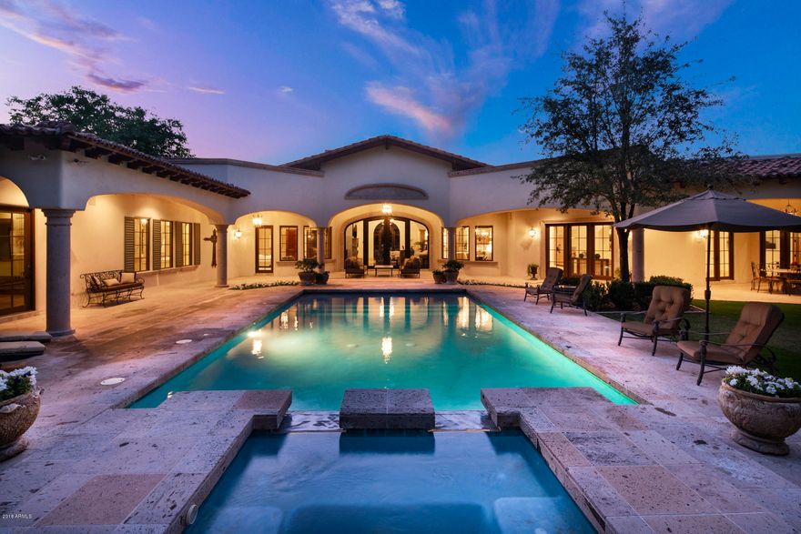 Designed for the ultimate private sanctuary setting this stunning Santa Barbara custom home is situated on a private quiet acre lot in the heart of Paradise Valley. This gorgeous custom home features 5 bdrms/5.5 baths/guest casita/sep. theatre rm/sep. office & library/sep. exercise rm/& a 600 bottle separately chilled wine cellar.  Additionally this home boasts an open floor plan with a decadent Chef's kitchen that opens to a lg. great room & breakfast room--all overlooking the resort style backyard w/ ramada & huge pool & spa w/ water features & a built in BBQ center----with lushly green mature landscaping surrounding you.  The Chef's kitchen features a highly upgraded Viking appliance pkg. including Viking dual fuel range w/ double ovens, a Viking refrigerator/freezer, a Viking warming oven, & double Bosch dishwashers.  The Chef's kitchen has beautiful custom alder cabinetry & all new white marble counter tops!  The formal living rm features 18 ft. high ceiling & hand sewn wood beams + a lg. masonary fireplace w/ creme colored canterra stone fireplace surround & custom wood flooring.  The formal dining rm. boasts groin vault ceilings & double french doors to a charming outdoor courtyard w/ masonary fireplace /w creme colored canterra stone surround. Additionally the formal dining room has a 600 bottle wine cellar room & a lovely butler pantry area.  The decadent master suite is truly fabulous w/ the master bedroom featuring a masonary fireplace w/ creme colored canterra stone surround & views overlooking the lushly landscaped resort style backyard.  The expansive master bathroom boasts separate HIS/HER vanities, HIS/HER water closets & HIS/HER separate walk-in closets plus a lg. walk-in shower w/ custom stone tiles & a spacious jacuzzi tub.  Additionally the master suite features a sep. exercise room.  Buyers will love watching their favorite sporting event or favorite movie in the big screen theatre room--the ultimate fun zone! The secondary bedrooms are all ensuite & feature nice walk-in closets.  The guest casita will be a favorite for your guests --lots of privacy & comfort!