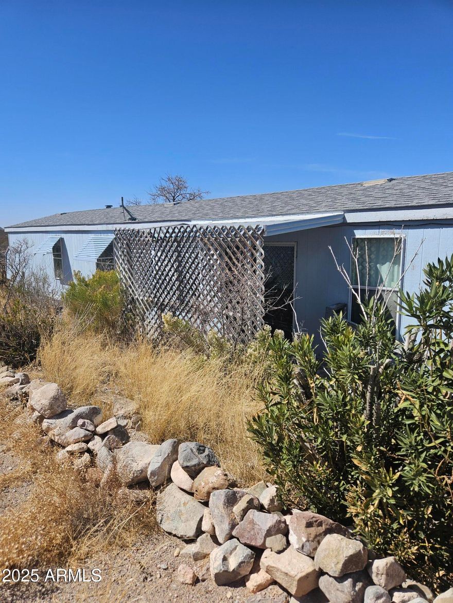 Within a few miles of the main Tombstone attractions. 3 bedroom with split floorplan, 2 full bath home. Large kitchen island with good storage and built in hutch. Decent sized lot with Desert Views from the backyard. Shed has electricity and a work space with an awning.