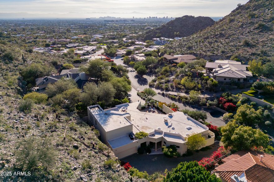 *Currently the only home in 85018 in a guard gated community with city lights AND mountain views UNDER $3 mil.   This exquisite estate in prestigious guard-gated community Lincoln Hills is
perched atop its own private peak.  Fabulous lock & leave home with TWO Primary suites.  Beautifully remodeled open-concept kitchen features walnut & creamy custom cabinetry paired with Sub Zero and Wolf appliances.   A well-appointed butler's pantry adds an extra layer of convenience, perfect for hosting and keeping the main kitchen tidy.   Primary suite features relaxing sitting area, double sinks, vanity counter, sauna for wellness, and built in refrigerator with bar area.   Fabulous outdoor living w/ built in BBQ area, covered patios with majestic mountain views, & glittering city lights at night! Lincoln Hills backs the Phx Mountain Preserve for access to hiking trails, community tennis court, pickleball, basketball court, grassy area for dogs, and community pool (in addition to your private pool). *FURNITURE AND DECOR ARE AVAILABLE TO PURCHASE on separate bill of sale.