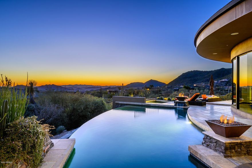 This wonderfully updated home in 2017 and 2018 offers views from every room and expansive city light views encompassing panoramic sunrises over Four Peaks and Superstition Mountains and sunsets over the White Tank Mountains from a single vantage point. Perfectly situated in the elevated village of Sunset Canyon with a sweeping wall of glass and large door in motion for indoor and outdoor living. Your private master retreat with romantic fireplace for crisp nights offers stellar views even from the custom-designed master bath. Your guests will enjoy privacy and comfort in any of two additional bedrooms in the main house and the spacious detached casita. The expansive great room plan with beautiful floor to ceiling water feature at entry flows into an elegantly appointed chef's kitchen with luxurious granite slabs, custom cabinetry and top of the line Viking appliances. Step outside to a fully accessorized covered outdoor kitchen with Viking appliances complete with large range and hood, dishwasher, warming drawers, ceiling heaters, large capacity ice maker, dual fridges, stainless accessorized drawers, granite tops, TV's and full smart controls for all A/V and surround sound throughout home. Enjoy the extensive outdoor living and dining spaces, outdoor fireplace, fire pots and endless views and colorful Sonoran Desert skies. Infinity pool, spa and ample decking provide the perfect venue for entertaining. This home brings the outside in and reflects the true Arizona Lifestyle. Desert Mountain Lifestyle Membership available via separate bill of sale. Most furniture, electronics and accessories available via separate bill of sale as well. See Document tab for list of Improvements, HOA Addendum and Seller Property Disclosure Statement.