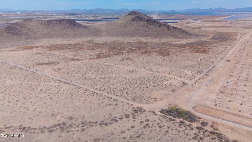 5.02-acre R-43 parcel in Maricopa County, west of Buckeye in the West Valley growth corridor. Flat Sonoran Desert floor with sparse scrub and minimal clearing needed to site a home. Dirt road access along the west and southwest boundary. R-43 (Rural-43) zoning permits rural residential use on a one-acre-minimum lot basis, with room for ancillary agricultural activity such as livestock. No HOA, no CC&Rs -- build timelines, design, and land use stay flexible. 5.02 acres, R-43 (Rural-43) zoning Dirt road access on west/southwest boundary Flat Sonoran Desert terrain, sparse scrub APS electric available; well required (300-600+ ft); standard septic; propane No HOA, no CC&Rs Suitable for an owner-builder homesite, small agricultural use, or long-term hold in a documented growth area.