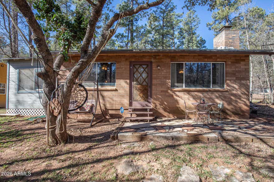 New listing price has been reduced to make this cabin affordable for a buyer to give it some updating and refreshing yard-grooming. Solidly built on a generous .32 acre lot, with beautiful trees for privacy. Inviting slate fireplace brings a warm ambiance, while you enjoy Deer and Elk wandering through this part of the forest. Two bedrooms plus bonus room, being sold 'As-Is' with plenty of room to expand or add a garage. Time to relax... restore... enjoy!