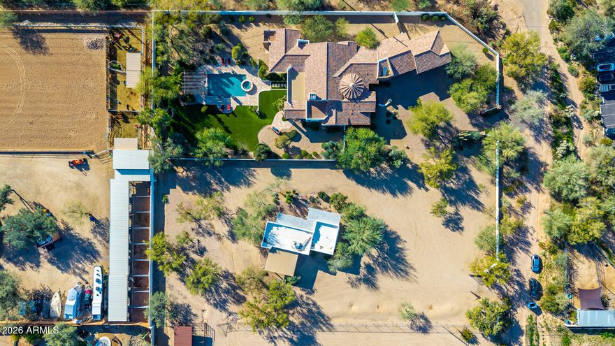 This listing is for the Main House + Guest House only. Please see MLS#6971415 & MLS#6971325 for additional configurations for the Main House only OR the Main House + Guest House + Vacant together. 

NESTLED on an oversized corner lot & featuring 4,666 sq ft with a stunning façade w/ tasteful stone accents, a manicured low-care landscape, a 4-car oversized garage w/ built-in cabinets, and a circular paver driveway. Come inside to discover a welcoming circular foyer, which flows seamlessly into a spacious great room showcasing high ceilings w/ exposed wood beams, a wet bar, and an impressive fireplace to keep you warm during the cold winter months. Travertine stone flooring, dazzling light fixtures, and neutral palette throughout! The gourmet kitchen is worthy of a chef, equipped w/ ample cabinetry, a walk-in pantry, granite countertops, honeycomb tile backsplash, SS appliances, and a center island w/ a breakfast bar for casual dining. The kitchen includes 2 dishwashers, 1 subzero refrigerator, and 1 Wolf double oven. If you like entertaining, you will love the dining area that is conveniently located off the kitchen where you can enjoy formal meals with family or friends in style.  

You'll be amazed by the grand master bedroom, with plush carpet, a huge walk-in closet with built-in shelving and washer & dryer hookups, a 2nd fireplace, and a lavish ensuite bathroom w/ dual vanities, a large tiled shower,  plus a jetted tub. The secondary bedroom can be used as a mother-in-law suite or second master bedroom with a separate entrance to the backyard with  its own private bathroom as well as a dry bar.  The remaining 2 bedrooms are ample size with their own private bathrooms.  There is a separate laundry room inside with plenty of storage and a utility sink. 

Outside, you will find a huge resort-style backyard including a covered travertine patio & decking, extended seating areas, nice size grassy area for outdoor sports, a built-in BBQ area, a lovely pergola, a sparkling blue pool, and a refreshing spa. 

Separate guest house included in this listing features 2-bedrooms, 2-bathrooms, 2-carport spaces, plus its very own living room and kitchen w/ blue glazed tile countertops and Saltillo tile throughout. There is paver parking under the carport.  The washer & dryer will convey. Interior paint (2024) & exterior paint (2026). The backyard is very spacious and is adjacent to the main house to the west & vacant land to the east. A designated septic system is included with the guest house. 

The main house includes 4,666 square feet APN# is 211-44-070-C. The guest house includes 1,160 square feet APN# is 221-44-070-B.

All three MLS#6971383, 6971325, and 6971415 must be sold as specified on MLS. No portion of the listing can be sold separately other than the main house.