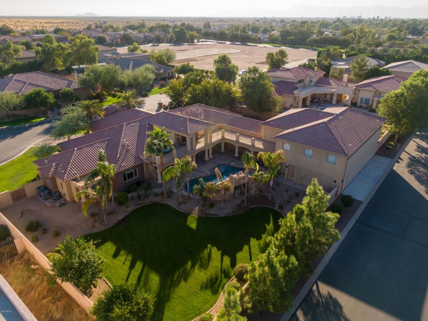 Stellar Airpark Estates, where an elite come-and-go lifestyle is a reality for those who call this community home. This prestigious gated community offers residents direct access to a private lighted runway, where you can be airborne within minutes. From the moment you arrive through the gracious entry, you'll be taken by the attention to detail and artistic design elements. This incredible estate features a nearly 2,500 square foot air conditioned airplane hangar. A pilot or car collectors dream! When you include the main home's garage & hangar, you can easily fit over 16 cars, RV or your plane. This exquisite property offers 4 en suite bedrooms, a full basement with 2 bonus rooms & wet bar, as well as a second floor 5th bedroom/study with observation deck & convenient separate entrance. Whether engaging in informal family breakfasts, or elegant dinner parties, the chef's kitchen serves as a spectacular focal point to this flawless home. Multiple indoor and outdoor living spaces offer the perfect backdrop for intimate gatherings, and the sophistication required for large-scale entertaining. The incomparable design is intentionally comfortable, yet naturally elegant. The large 20' sliding glass door will lead you out to the resort style backyard, where you will find a private pool with granite waterfall, spa, outdoor kitchen and plenty of lush grassy area. As the day winds down, the master retreat is a true escape. Offering a sitting room, fireplace, patio, his/her toilets, bidet, steam shower, jet tub, and massive custom walk-in closet. Other amenities include; designer lighting, 3 built in wine chillers, many smart home and energy efficient features, where you can control the sonos sound, lighting, main gate, garage doors and pool individually from your smartphone. All of this is close to everything the valley has to offer, including fine dining and shopping at the Chandler Fashion Center, convenient freeway access, and highly sought after Chandler Schools.