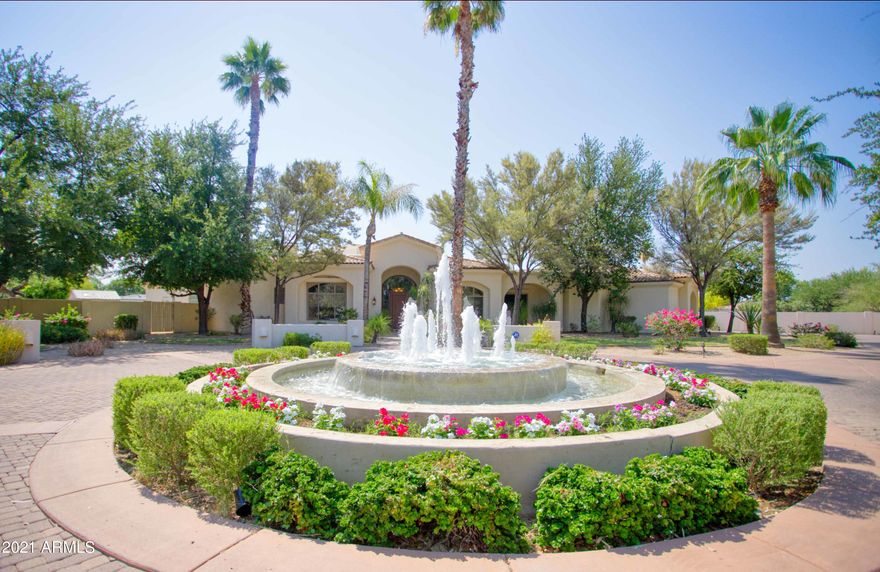 Gorgeous home in an exceptional Paradise Valley location. Drive in to the gated entry with a tranquil fountain. Enter through the foyer with views directly to your backyard paradise that is just shy of an acre. The living room impresses with wall to wall pocket doors that lead directly to your entertaining patio. The split floorplan features stone and wood flooring throughout and 5 en-suite bedrooms with walk-in closets. The grand chef's kitchen is highlighted by the center island, bar seating, 2 of almost every appliance, butler's pantry, and overlooks the family room and wet bar. The private master suite is complete with luxurious master bath, sitting area, exercise room or office, fireplace, his and hers closets. The lush backyard offers multiple entertaining areas, The lush backyard offer multiple entertaining areas, pool, spa, flowing water fountain, built-in BBQ, and outdoor kiva fireplace. The oversize 4 car garage has built-in cabinets and room for all the toys. This is truly an outstanding property with comfort, amenities, and privacy in one of the best locations in town.