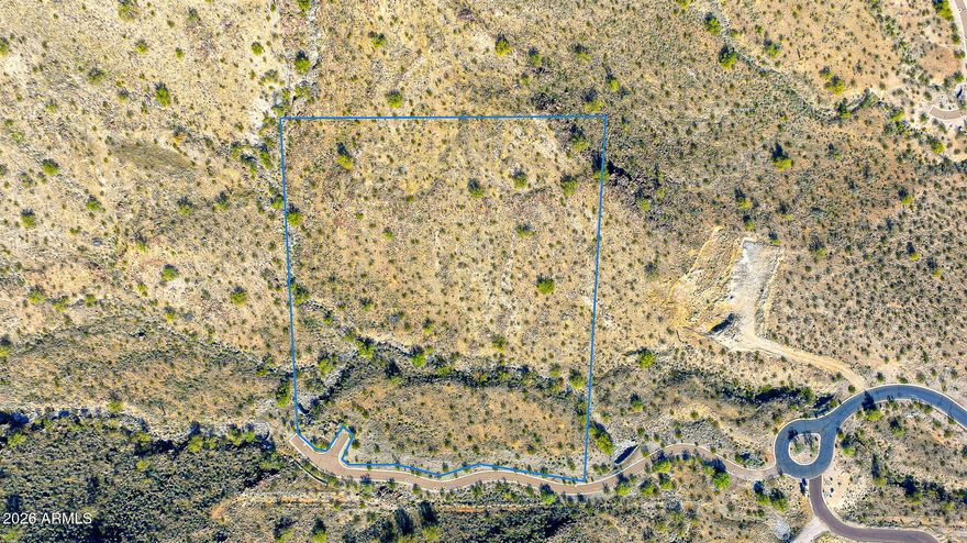 Experience the best of desert living and modern convenience with Homesite #2 in the prestigious Mountain Coves Enclave of Verrado. Set against the White Tank Mountains and accessed via a private, secluded driveway, this 4.32-acre mountainside homesite offers remarkable privacy, space, and natural beauty. Enjoy sweeping panoramic mountain views, dazzling city lights, and dramatic Arizona sunsets from a truly one-of-a-kind setting.

The Sonoran Desert landscape blends seamlessly with Verrado's signature tree-lined streets and welcoming small-town atmosphere. Residents enjoy access to over 80 parks and greenbelts, two Tom Lehman-designed championship golf courses, and a vibrant City Center featuring shopping, dining, fitness facilities, pools, and highly rated schools. With a wide array of clubs, events, and amenities, Verrado delivers an active lifestyle for every stage of life. An exceptional opportunity to build a custom dream home in one of the community's most private and scenic locations.