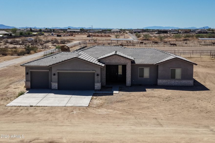 2023-built popular MTH Alpine model on a flat 1-acre lot with NO HOA! This 2,138 sq ft home offers 4 bedrooms or 3 bedrooms plus den/office, 10' ceilings, tile plank flooring throughout with no carpet, blinds, kitchen appliances, and an attached 3-car garage. Plenty of room for horses, an RV garage, toys, or just room to roam. Only four homes share the well. Located just off Patton Rd, minutes from the new Fry's, restaurants, and more at 163rd Ave.