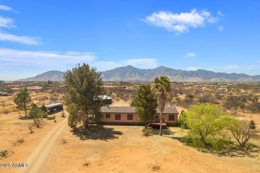 BACK ON THE MARKET BY NO FAULT OF THE SELLERS OR THE PROPERTY. Welcome to wide-open living beneath Arizona's iconic skies. Nestled on 4.32 serene acres in the heart of Hereford, this well-maintained 3-bedroom, 2-bath manufactured home offers nearly 2,016 square feet of spacious comfort with all the room you need to stretch out, grow, and thrive. Built in 2000, this doublewide gem features an open-concept layout that flows beautifully from living to dining to kitchen, ideal for family living, entertaining, or simply soaking in the quiet of the desert. Outside, a massive covered carport shelters up to three vehicles, with extra storage space for your tools, toys, & gear. This is more than a property; it's a lifestyle of freedom, space, and potential. Whether you're a car enthusiast, hobbyist, or simply someone who loves a bit of elbow room this property delivers.

And there's more a separate barn offers endless opportunities for horses, homesteading, or workshop potential. Bring your animals, your dreams, and your sense of adventure.
No HOA, no fuss just a slice of high-desert heaven with unmatched views, crisp air, and plenty of room to roam. Located just minutes from Sierra Vista and only a short drive to Bisbee, this property combines tranquility with convenience.
Looking for freedom, functionality, and a whole lot of sky?
You've just found it.
