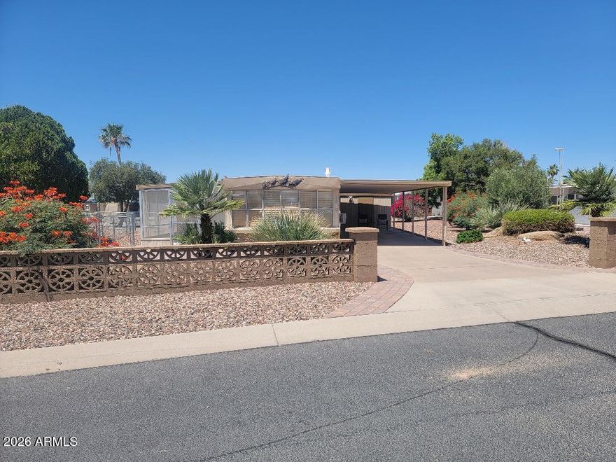 This is a lovely 2 bedroom 2 bath home. Partially furnished clean home  with all appliances that convey. The home has  updated features done with both bathroom fixtures, an flooring throughout.  The Ac wall unit in the family room is 3-4 years old. The roof was recoated in 2026. A full landscaped watering system was added, and water heater was replaced 2 years ago. The open floorplan is spacious and inviting! There is a 265 sq ft screened in Az room, and a fenced yard for your pet. A shed offers storage and the washer and dryer laundry area. This home is a wonderful, well taken care of Oasis and a great place to enjoy the lifestyle of Florence Gardens. Heated pools and spas, pickle ball courts, golf course, craft rooms, billiards hall, work out room, and library and more! You OWN THE LAND!