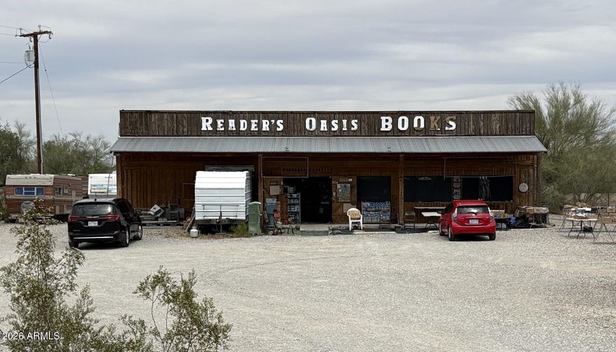 Historic Quartzsite commercial property now available for sale. Reader's Oasis Bookstore is situated on 0.91± acres with approximately 125± feet of frontage along Main Street in Quartzsite, Arizona. This high-visibility C-2 zoned property includes an approximately 60' x 40' metal building on a concrete slab with power and water onsite. Located just off Interstate 10, Quartzsite attracts hundreds of thousands of seasonal visitors annually for RV gatherings, gem and mineral shows, and desert recreation. Known for its unique character and local history, this property offers potential for retail, commercial, investment, or redevelopment use. Property sold as-is. Reader's Oasis Bookstore | 690 E Main St, Quartzsite, AZ

A rare opportunity to acquire one of Quartzsite, Arizona's most recognizable commercial properties. Located along historic Main Street, Reader's Oasis Bookstore has long served as a destination for travelers, winter visitors, and the local community. This unique commercial property offers strong visibility, excellent frontage, and redevelopment potential in one of Arizona's most active seasonal markets.

PROPERTY OVERVIEW:
" Approximately 0.91± acre commercial parcel
" Approximately 125± feet of frontage on Main Street
" Zoned C-2 (General Commercial)
" Flat, usable terrain
" No HOA

IMPROVEMENTS:
" Approximately 60' x 40' metal building
" Concrete slab construction
" Power and water onsite
" No sewer or septic currently installed

LOCATION:
Conveniently located just off Interstate 10 (Exit 19) with access to US-95, a major corridor connecting Parker and Yuma. Quartzsite is widely known for its seasonal population surge, attracting hundreds of thousands of visitors annually for RV gatherings, gem and mineral shows, swap meets, and outdoor recreation.

AREA & MARKET:
Quartzsite has evolved from a historic mining and stage route community into a nationally recognized seasonal destination. Main Street commercial properties benefit from strong winter traffic and visibility, creating opportunities for retail, commercial services, tourism-oriented businesses, or redevelopment projects.

PROPERTY HISTORY:
Reader's Oasis Bookstore was built and operated by Paul and Joanne Winer. Paul, known by many as "Sweet Pie" and the "Naked Bookseller," made the property a well-known stop for travelers and a memorable part of Quartzsite's culture and history.

PROPERTY DETAILS:
" Assessor Parcel Number: 306-23-002F
" County: La Paz County, Arizona
" Approximate Elevation: 900 feet
" Road Access: Paved Main Street frontage
" Utilities: Electric and water available
" Annual Property Taxes: Approximately $1,613 (2025)

This offering presents a unique opportunity to purchase a highly visible commercial property with historical character and commercial potential in the heart of Quartzsite, Arizona.