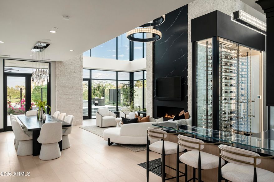 Tucked at the base of Camelback Mountain within the exclusive Ascent at The Phoenician, this newly constructed residence offers a sophisticated blend of contemporary design, thoughtful functionality, and resort-style living. Built by Cullum Homes, this customized floor plan spans 5,560SF, featuring 3 bedrooms, 3.5 baths, custom office, exercise room, loft area and three car garage with air conditioned storage. 
Designed for seamless indoor-outdoor living, the main level is anchored by a striking great room with expansive pocket doors that open to covered patios and frame sweeping mountain and golf course views. The chef's kitchen is beautifully appointed with Sub-Zero and Wolf appliances, complemented by a discreet butler's pantry/back kitchen that enhances both everyday living and effortless entertaining. 
A sculptural floating staircase and private elevator connect the home's thoughtfully designed spaces, including an upper-level loft and view terrace. The primary suite offers a serene retreat, while additional en-suite bedrooms provide comfort and privacy for guests. A dedicated in-residence fitness room further elevates the home's livability. 
Extensively upgraded throughout, the residence showcases refined finishes, abundant storage, and a rare air-conditioned garage with additional climate-controlled storage--an exceptional feature for the discerning collector. 
Residents enjoy a premier lock-and-leave lifestyle with access to exclusive community amenities and the option to experience the world-class offerings of The Phoenician, just moments away.