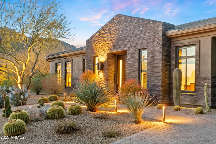 This is your opportunity to own in the highly sought-after Boulder Mountain Estates. Featuring the elegant modern European designs of internationally acclaimed Dutch designer Piet Boon, the home's spacious sophistication begins from the moment you walk through the front door and flows to every aspect of the residence including the 526sf guest house. Be captivated by spectacular, intimate views of both Troon Mountain and Tom's Thumb. With tons of natural light and seamless indoor/outdoor living, this home is ready to both entertain friends and family as well as be your own quiet preserve. The pristine kitchen with its subtle lines and stunning white cabinetry overlooks an expansive great room flowing to a beautiful resort-style pool area in a peaceful natural desert setting. The master suite boasts of two oversized walk-in closets with a spa-like bathroom. Views abound from every room in this home, making it a true must-see.