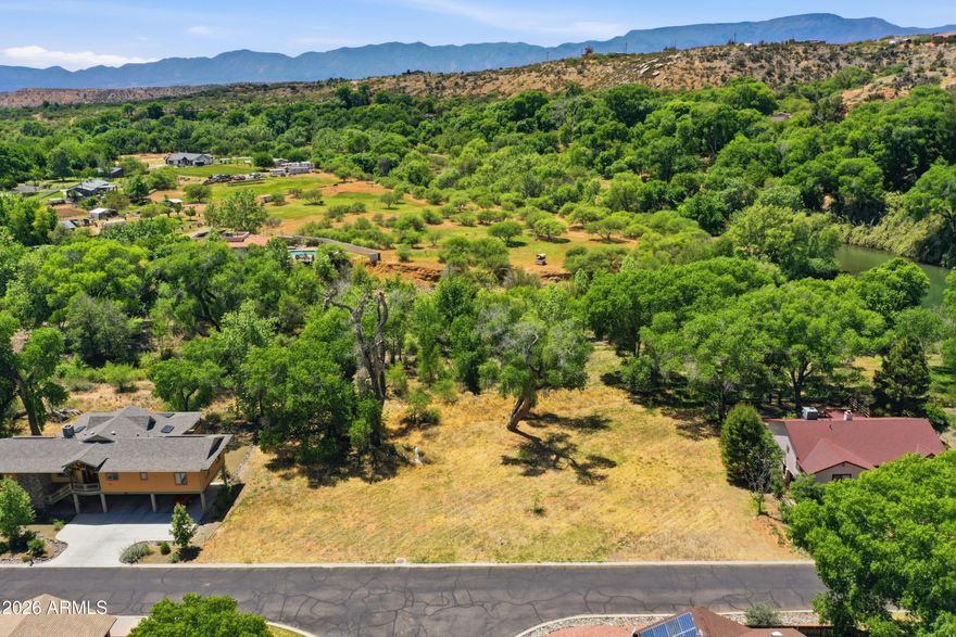 Ready to build Oak Creek Valley beauty, this rare homesite offers a spectacular opportunity at the confluence of Oak Creek and Spring Creek. Residents of this peaceful gated community enjoy exclusive creek access, along with clubhouse, pool, tennis/pickleball courts, manicured parks, scenic trails, and private float launch. Ideally located steps from the community park and creek access, enjoy fishing, swimming and abundant wildlife. Sellers have completed nearly all the groundwork to bring a stunning modern home to life, saving time, money, and uncertainty. Included in sale are topography/soil testing, survey, grading report, floodway report, and custom building plans. With few vacant lots in this unique and sought after community, opportunities like this are increasingly limited.
