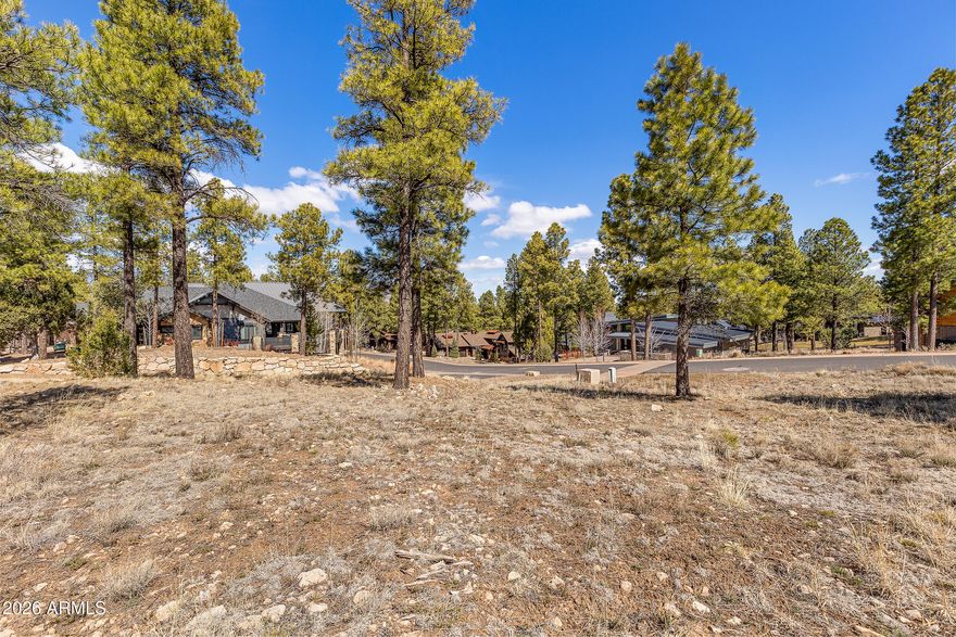 Situated within the prestigious Estates at Pine Canyon, this 0.55-acre homesite offers unobstructed views of the iconic San Francisco Peaks, creating a stunning backdrop for your future mountain retreat. The lot's positioning allows for protected views that will remain undisturbed by neighboring homes, a rare and highly sought-after feature within the community. Surrounded by towering Ponderosa pines and luxury custom residences, this homesite provides the ideal setting to design and build a private escape while enjoying the cool mountain climate of Flagstaff. Located on a quiet street within the Estates section, the property offers both privacy and proximity to Pine Canyon's exceptional amenities. Residents enjoy access to a championship golf course designed by Jay Morrish, a private clubhouse, state-of-the-art fitness center, resort-style pool, tennis and pickleball courts, and multiple dining venues. Outdoor recreation is endless with nearby hiking and biking trails, and skiing at Arizona Snowbowl just a short drive away.
Whether you're looking to build a seasonal getaway or a full-time residence, this homesite presents a rare opportunity to create a custom home with sweeping San Francisco Peak views in one of Northern Arizona's most sought-after private communities.