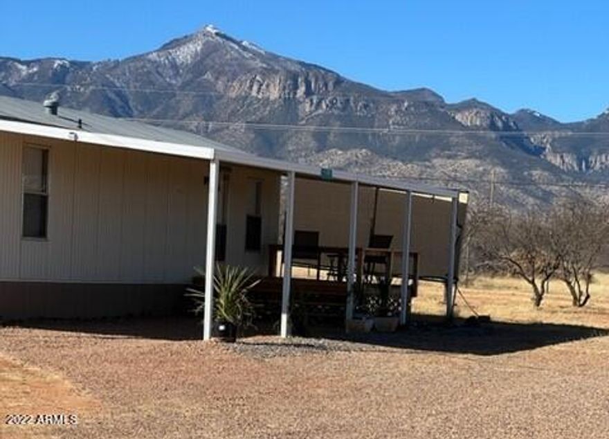 PERFECT WINTER HOME WITH MOUNTAIN VIEWS! Located on a prime corner, 4 acre parcel. Bring your horses, family and friends! This lot is completely fenced with paved roads on both sides, RV gate, 2 FULL RV hookups, 2 Large Storage Sheds, Central A/C, Carport and Majestic Mountain Views! Plenty of room to spread out! This would make a nice starter home or the perfect seasonal home for a lucky buyer! Plus, a PRIVATE WELL! This 1 bedroom/1 bathroom remodeled home is MOVE-IN ready and completely Furnished with Newer appliances including washer, dryer and refrigerator. Enjoy your morning brew and mountain views on the beautiful front deck or enjoy a game of horseshoes with your friends out back. Whatever you choose, call for a tour to view this home today!