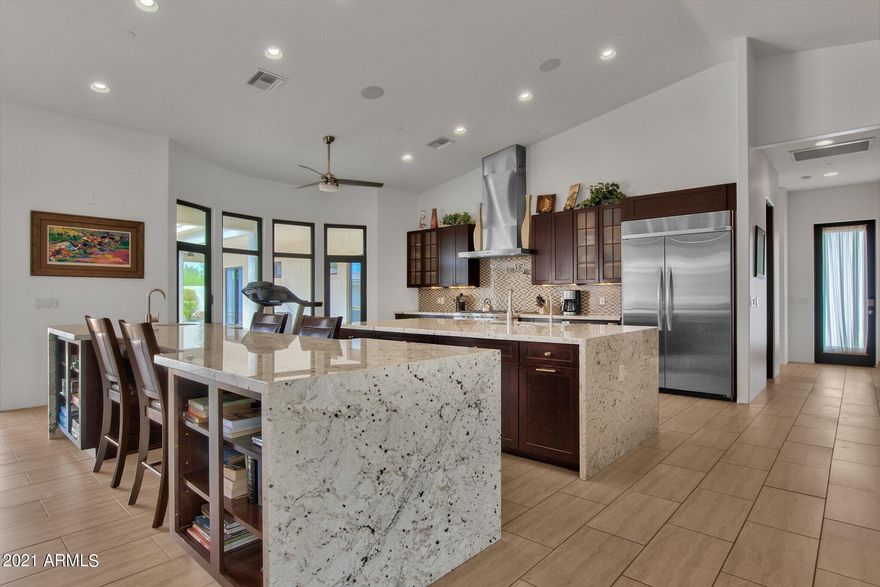 Modern Designed Custom Built Home!...4849 sq ft in Main House boasts a Chef inspired KITCHEN with double islands, top of the line stainless appliances overlooking a GREAT ROOM floor plan with POCKET DOORS that lead to 2521 sqft of covered patio/cabana spaces, sparkling pool, built-in BBQ & fire pit...This Compound includes a fully equipped 750 sq ft -1 bedroom Guest house, Media room, office, game room, 2 laundry rooms, 2 car garage attached to main and a tandem 4 CAR w/11 FT Doors to fit all your toys. No HOA! 10,000 sq ft under roof- Over an ACRE with circular drive and PRIVACY in the Heart of Scottsdale...A Great VRBO opportunity as well!